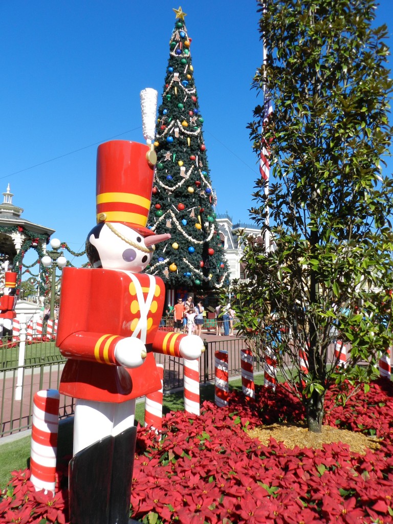 Mickey’s Very Merry Christmas Party is a great event to put on your Disney World solo itinerary! Red, white, and yellow toy soldier in front of Christmas tree.