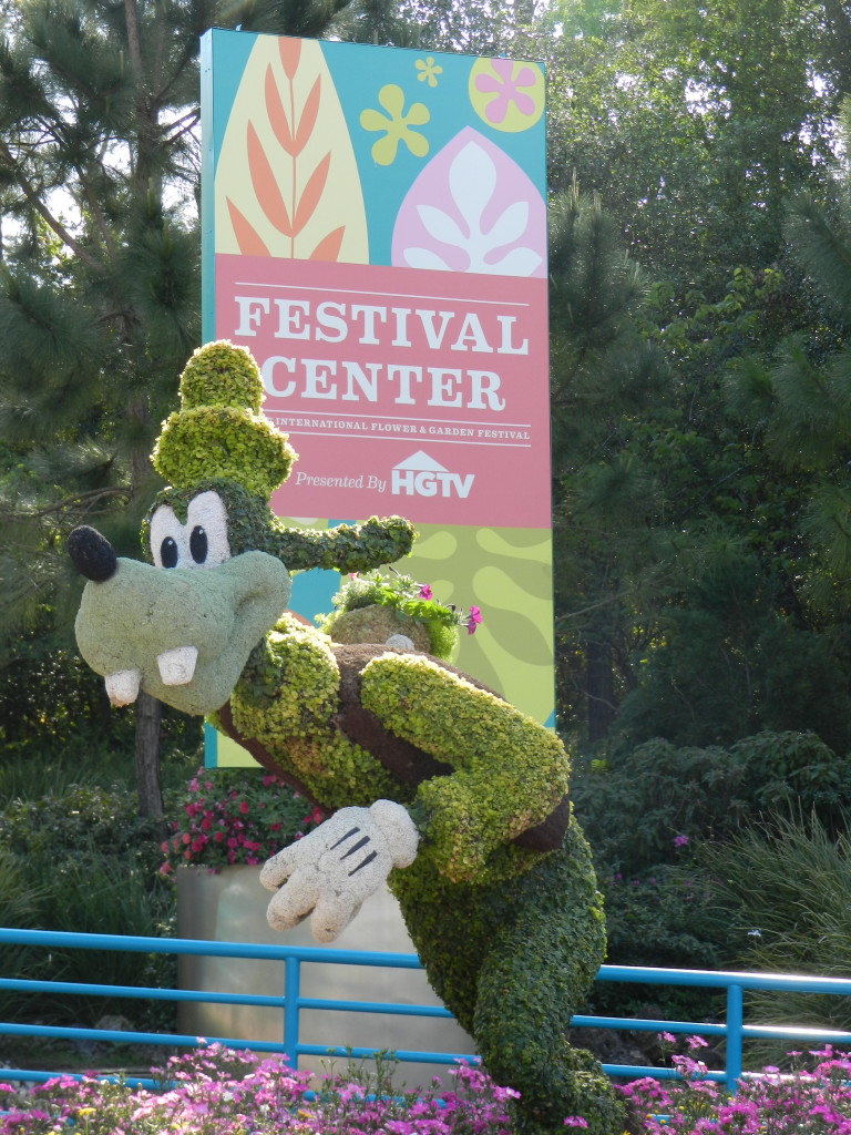 EPCOT Flower Garden Festival 2013 Festival Center entrance with Goofy topiary. Photo Copyright ThemeParkHipster.