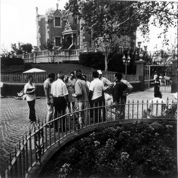 Tourist group near Haunted Mansion at the Magic Kingdom - Orlando, Florida in 1971. Keep reading for Disney World Haunted Mansion secrets and facts.