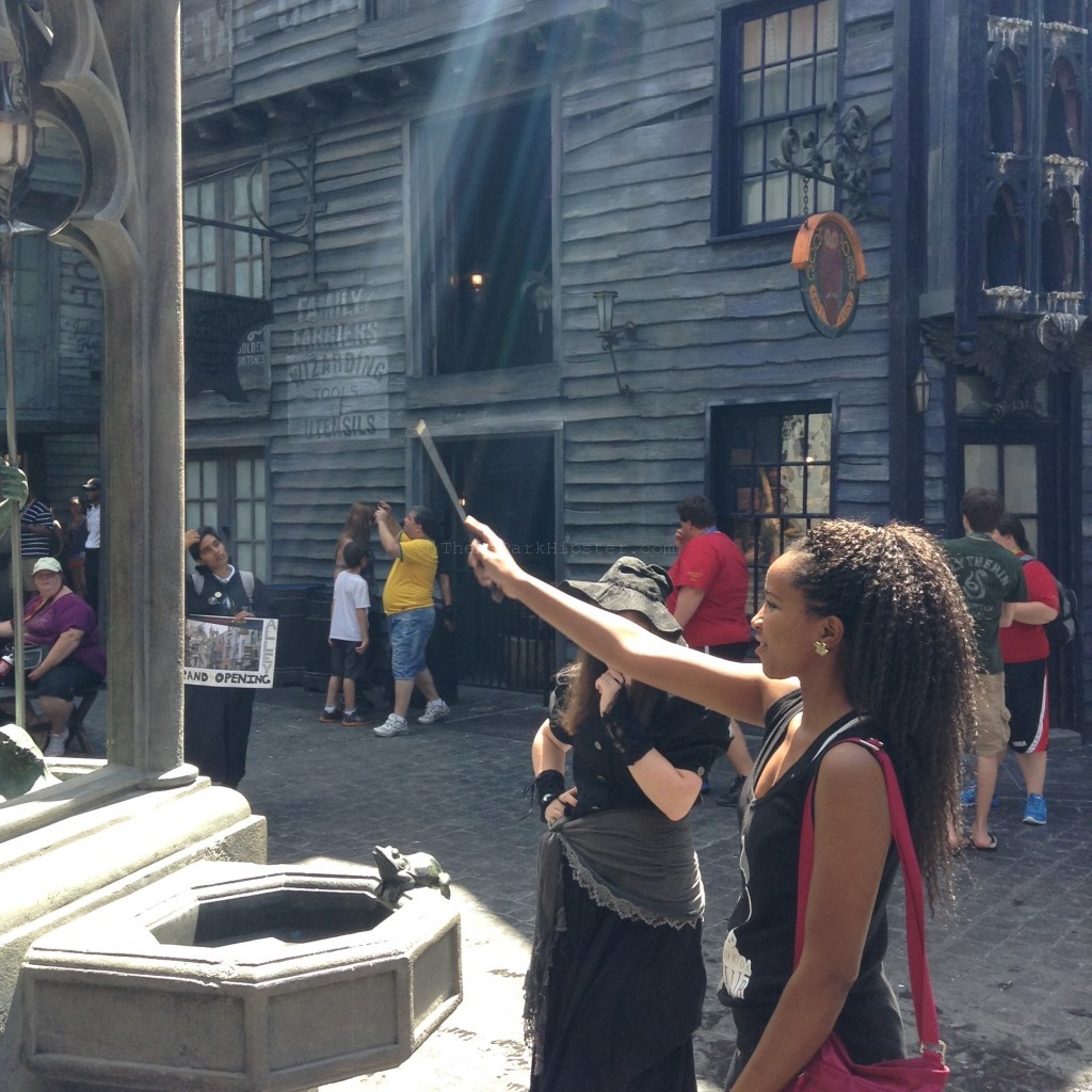 Wizards World of Harry Potter Diagon Alley with NikkyJ playing with wand as a  solo travel woman going to Theme Parks Alone.