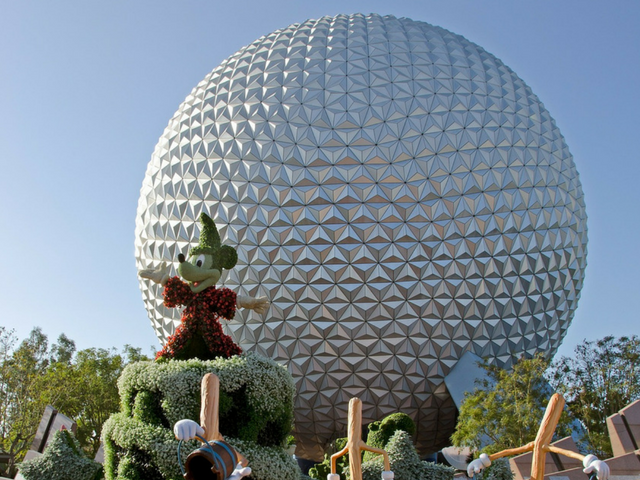 Mickey Mouse in front of Spaceship Earth Globe at Epcot.  A perfect photo spot for your Disney solo trip.