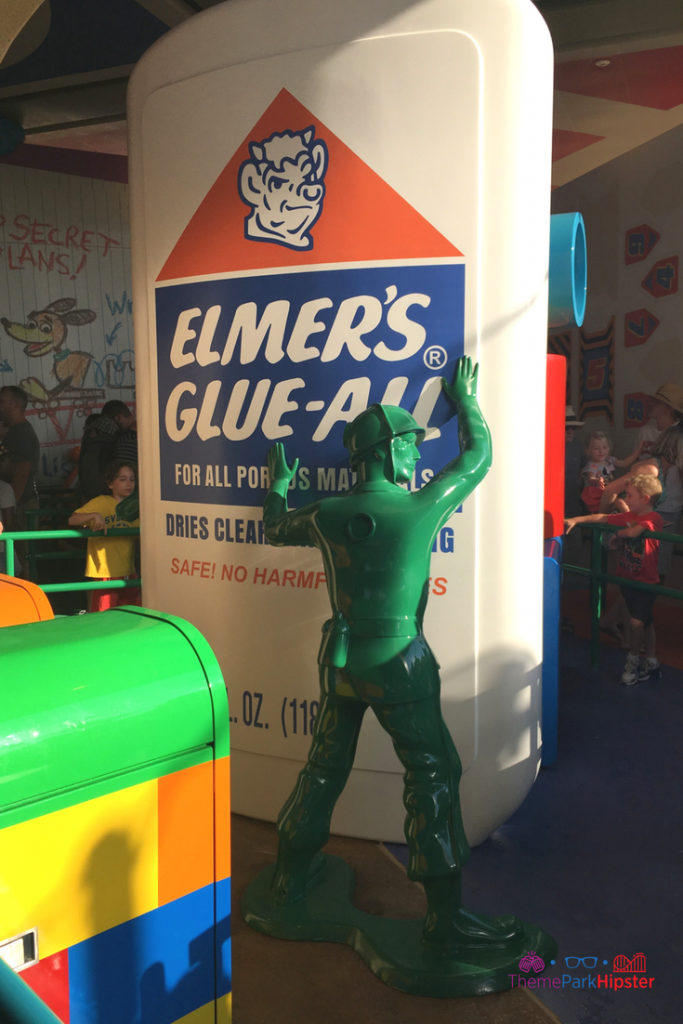 Toy Story Land tips with green army man holding up Elmer's glue.