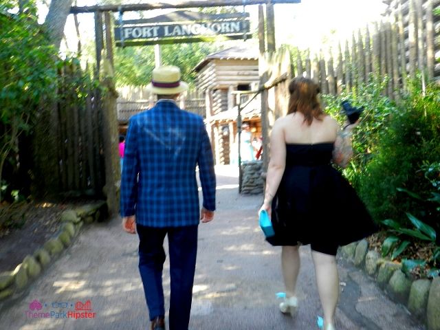 Dapper Day Disney World Tom Sawyer Island Fort with People Walking. Keep reading to get the best Dapper Day tips at Disney!