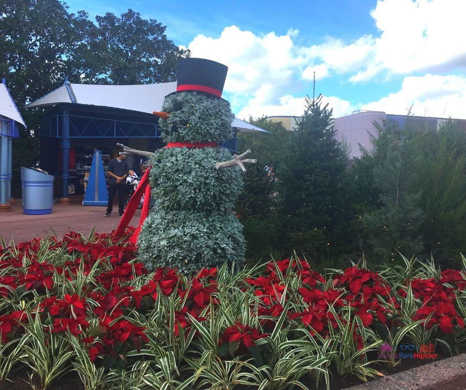 Epcot Festival of the Holidays 13 Park Entrance with Topiary Snowman Holiday Decor celebrating Christmas at Epcot.