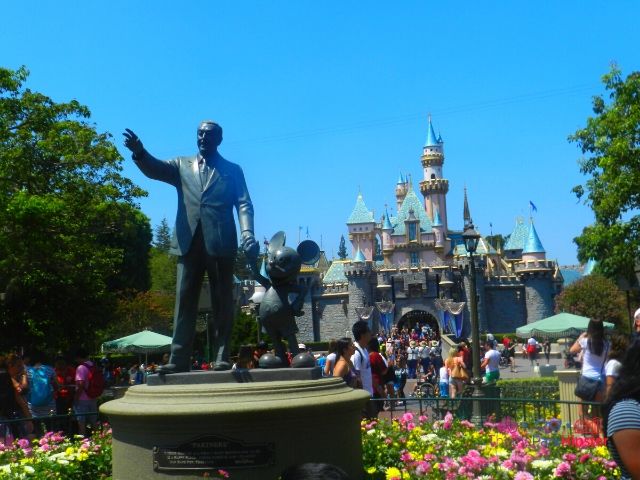Disneyland Sleeping Beauty Castle with Partners Statue of Walt and Mickey. Keep reading for your own Disneyland Itinerary!