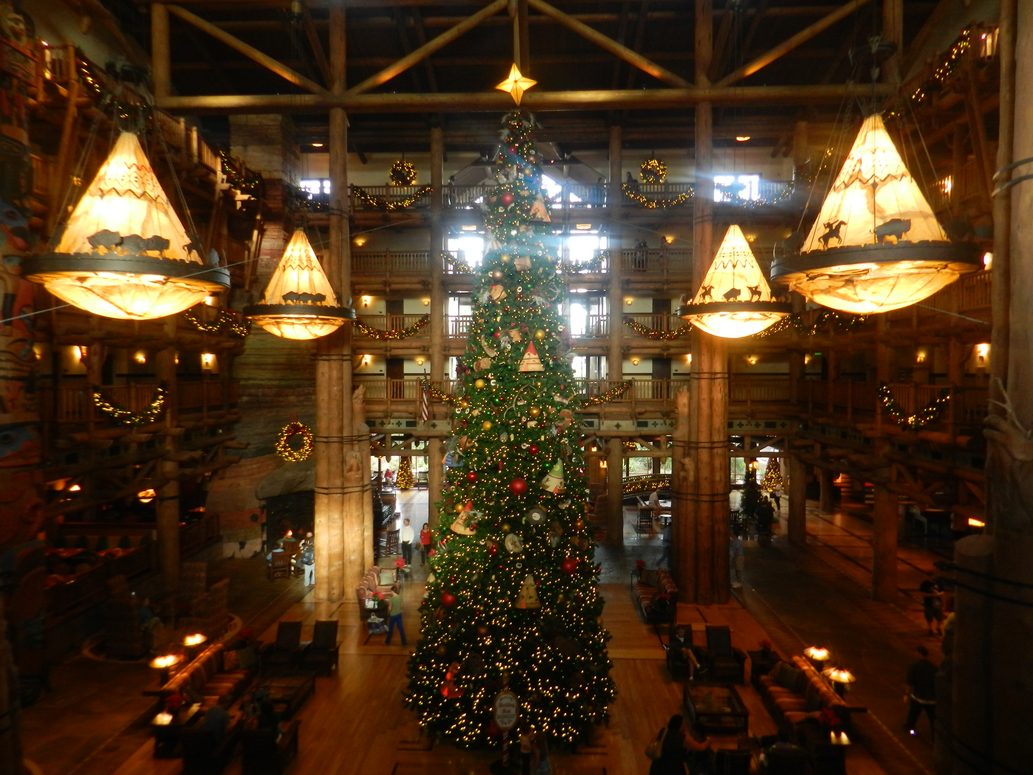 Christmas at Fort Wilderness Lodge Resort tall tree with logs cabin feel