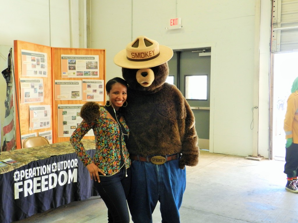 It's me and Smokey the Bear at the Florida State Fair in Tampa 2025. Keep reading to get the full Florida State Fair Guide with Tickets, Food, Concerts, Rides and More!