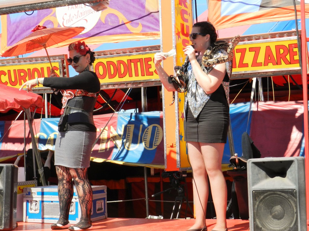 Carnival ladies with snake wrapped around neck at the Tampa Florida State Fair. Keep reading to get the full 2025 Florida State Fair Guide with Tickets, Food, Concerts, Rides and More! Copyright ThemeParkHipster.