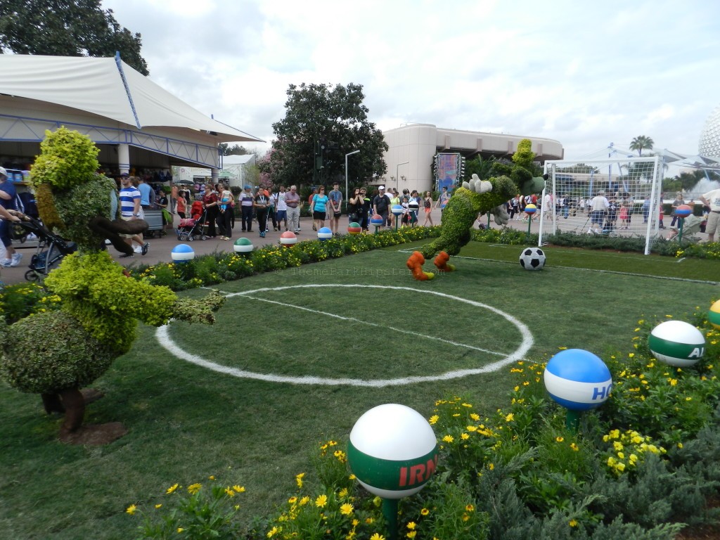 Epcot Flower and Garden Festival with Goofy topiary playing soccer. Keep reading to see the best epcot flower and garden topiaries through the years!