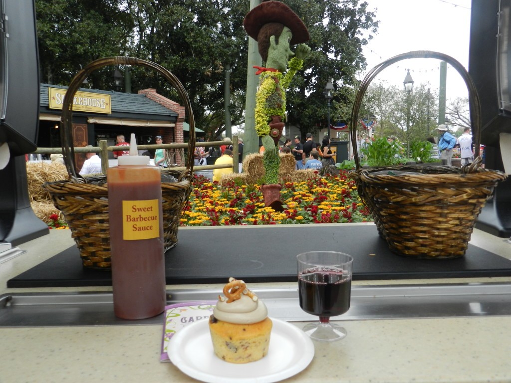 "Piggylicious" Bacon Cupcak with Maple Frosting and Pretzel Crunch with The Original Rib Shack Red Wine from The Smokehouse America Pavilion. Keep reading to learn about the Epcot Food and Wine Festival Concerts time and schedule at Eat to the Beat.