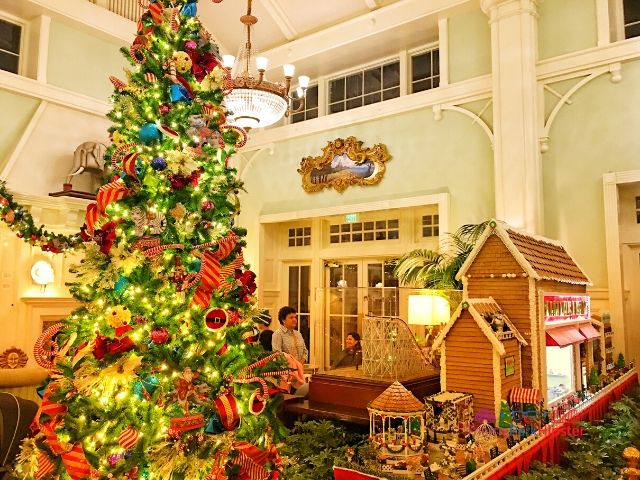 Boardwalk Inn Disney Gingerbread House Display with Majestic Christmas Tree. Keep reading to get the best things to do at the Magic Kingdom for Christmas and a full guide to Mickey's Very Merry Christmas Party Tips!