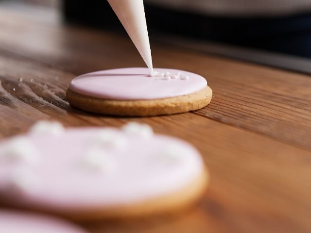 Placing icing on Gingerbread cookie