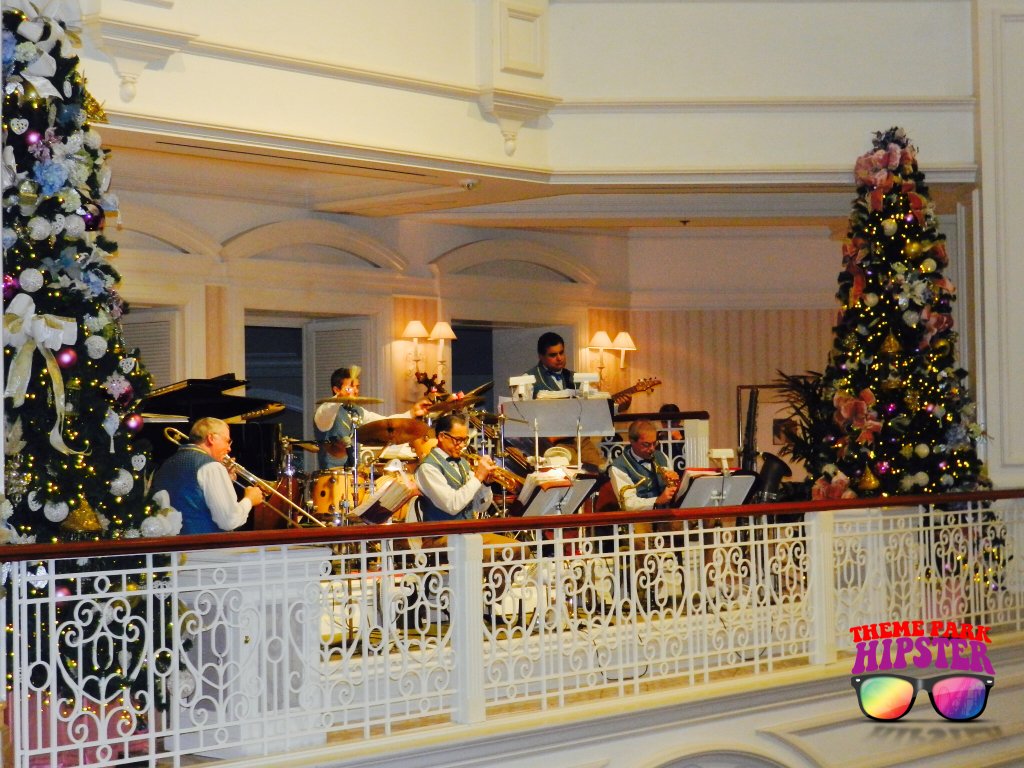 Christmas at Disney's Grand Floridian Resort and Spa with live band playing holiday tunes. Keep reading to learn about the best Disney Resorts at Christmas!
