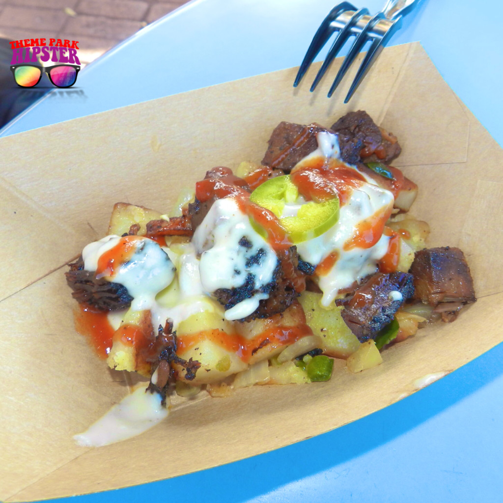 Epcot Flower and Garden Festival Beef Brisket Burnt Ends Hash with White Cheddar Fondue and Pickled Jalapenos. Keep reading to get the best things to do at Epcot Flower and Garden Festival.