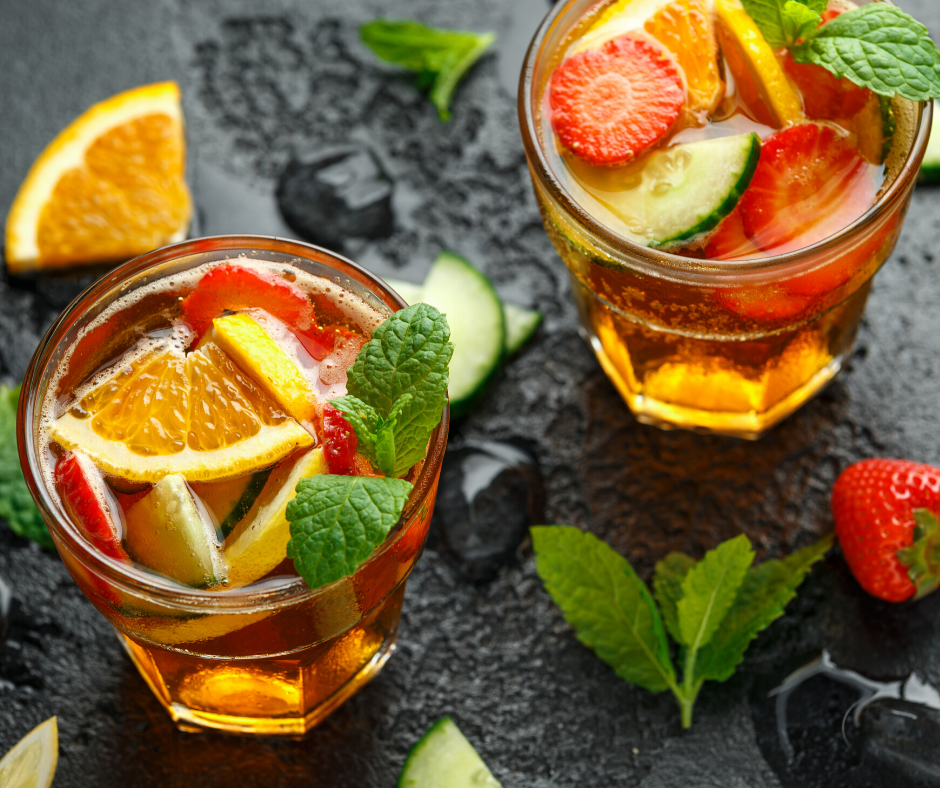 Pimm's Cup Cocktail at Epcot topped off with orange slices and strawberry slices.