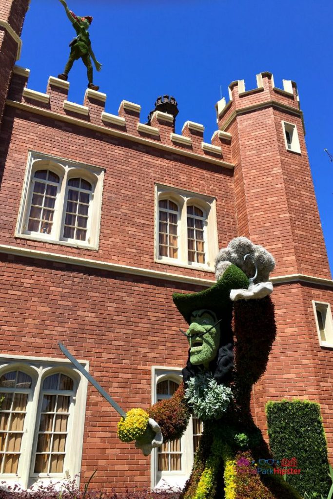 UK Pavilion at Epcot with Captain Hook topiary angry at Peter Pan