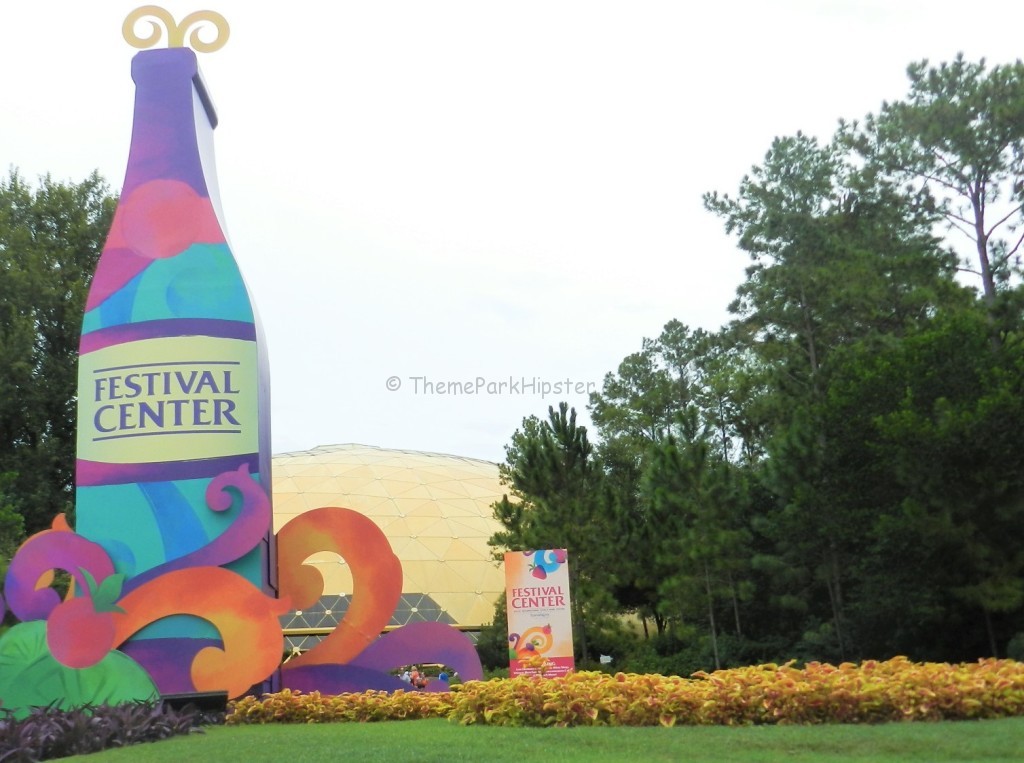 Festival Center at Epcot with purple, blue, and pink giant wine bottle for Food and Wine Festival