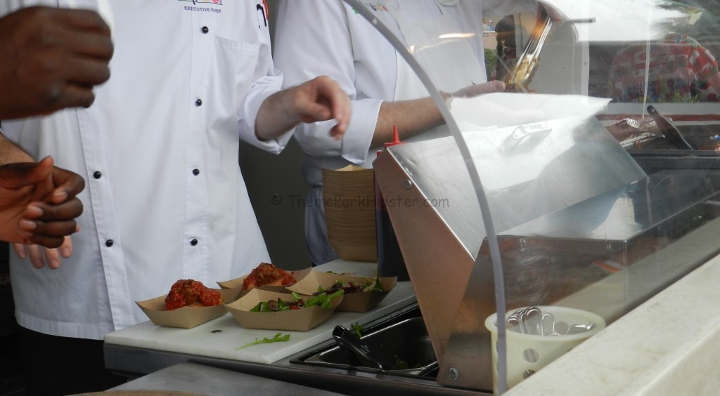 Chefs preparing food at Epcot Food and Wine Festival. Keep reading to learn about what's new and if the Epcot Food and Wine Festival is worth it?