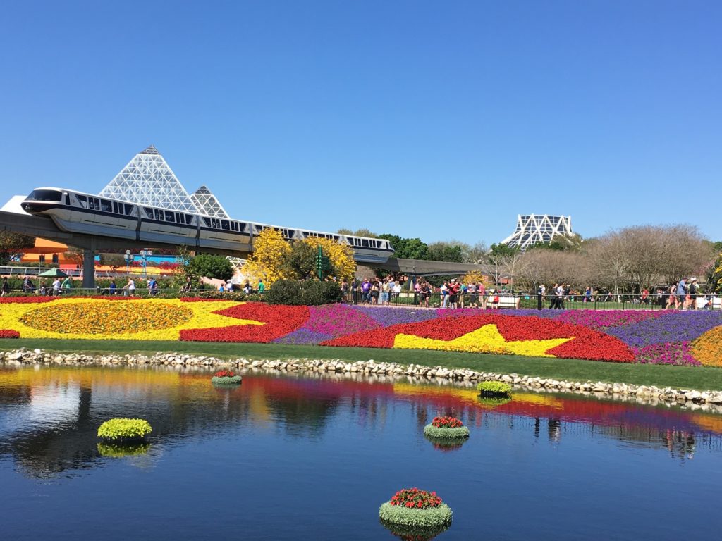 Epcot Flower and Garden Festival colorful topiary with monorail in the background. One of the best 2024 Epcot Festivals at Disney World!