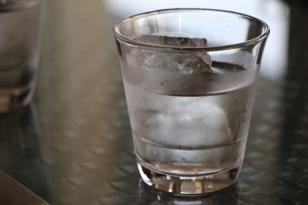 Glass of cold water on a theme park table.
