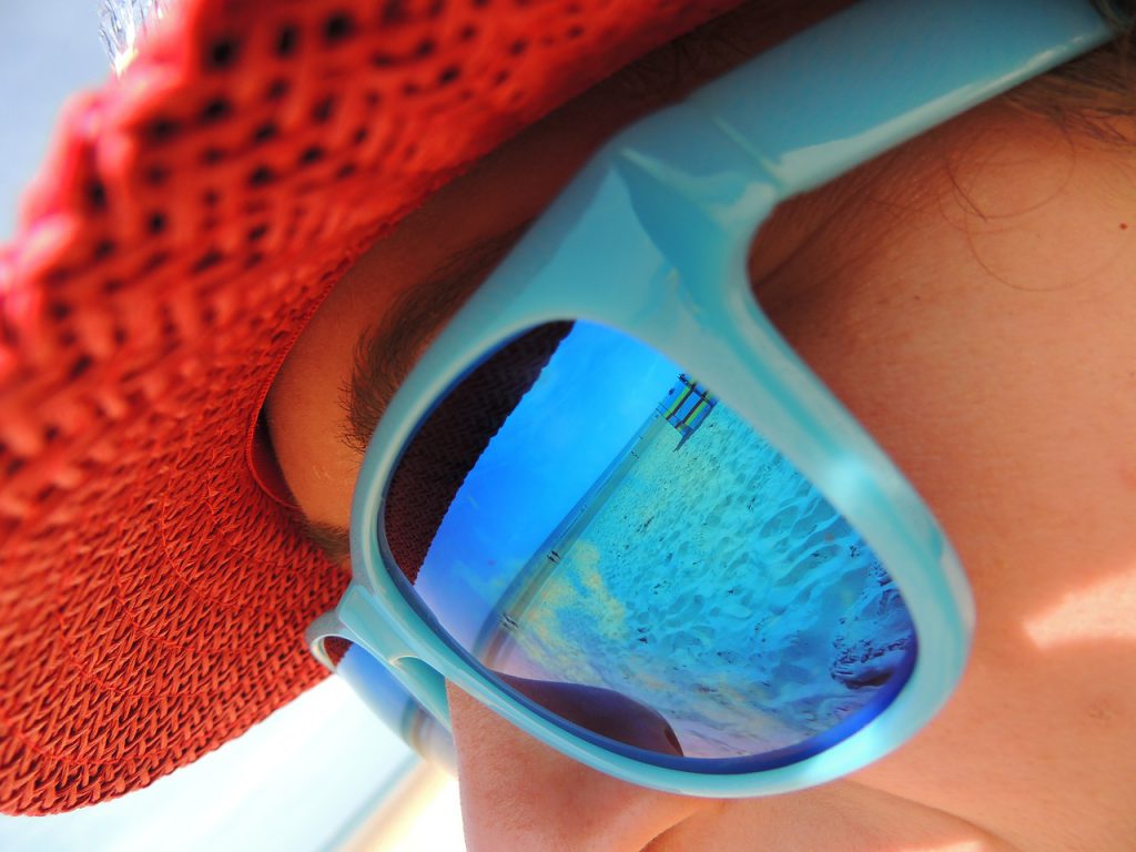 Lady wearing blue sunglasses in summer Florida heat.
