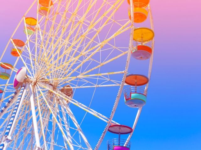 Theme Parks Alone Solo Female Travel with multi-color ferris wheel