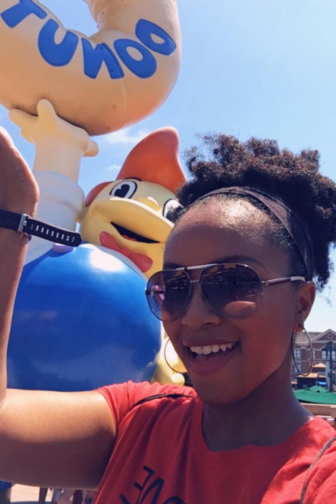 Lard Lad in Springfield Universal Studios Orlando Florida in front of Giant Doughnut Going to a theme park alone. Big Pink Simpsons donut.