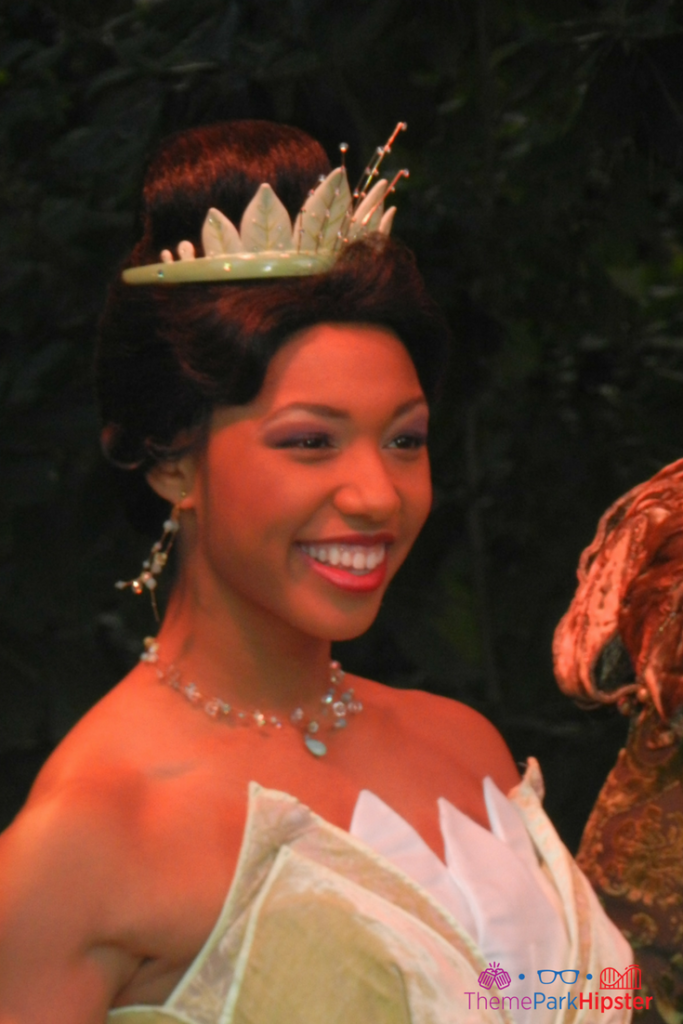 Princess Tiana in a beautiful gown at the Magic Kingdom. Keep reading to get the best rides at Magic Kingdom for Genie Plus and Disney Lightning Lane.