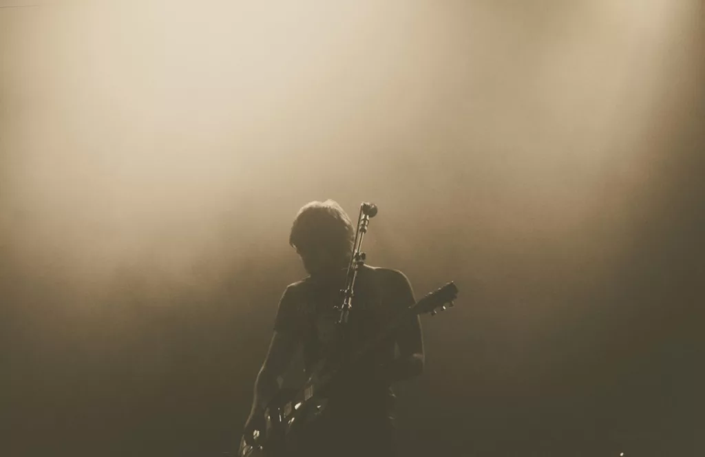 Concert with guy in the foggy shadow playing guitar. Keep reading to get the best things to do at Universal Orlando solo trip while going to Universal alone.