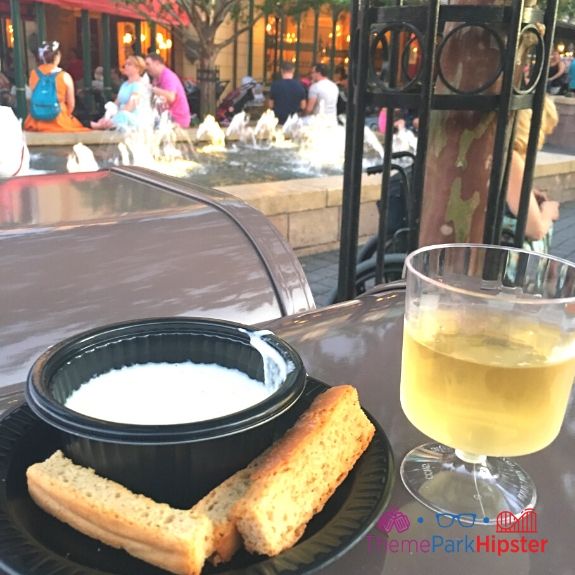 France melted cheese bread and wine at Epcot Food and Wine Festival. Keep reading to get the best Epcot Food and Wine Festival Tips!