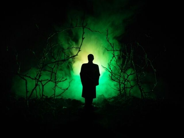 Things to Do in Orlando for October. Halloween haunted house in Orlando with creepy man in green fog.