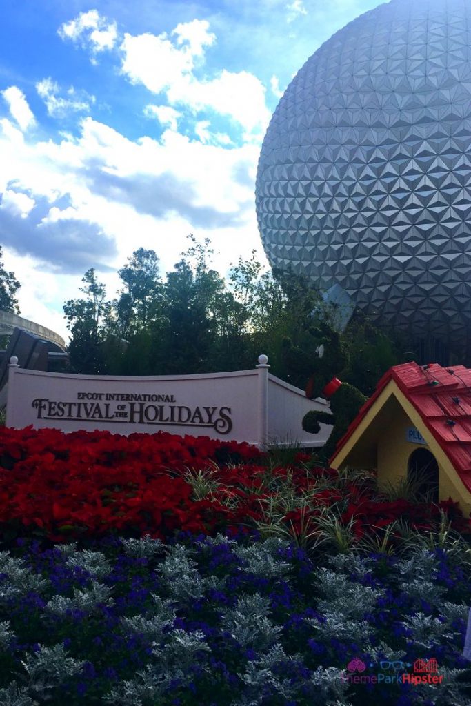 Epcot International Festival of the Holidays Entrance Holiday Decor Pluto Topiary. Keep reading to get the best Disney Christmas pictures and to know where to take the best Christmas photos at Disney World!