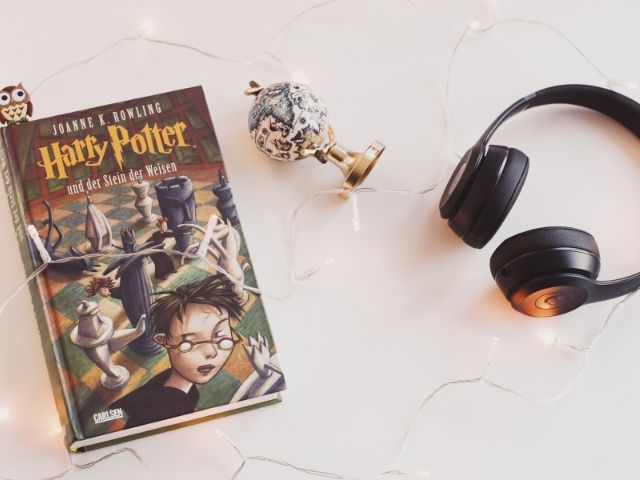 Harry Potter Book Series Universal Studios with book next to headphones.