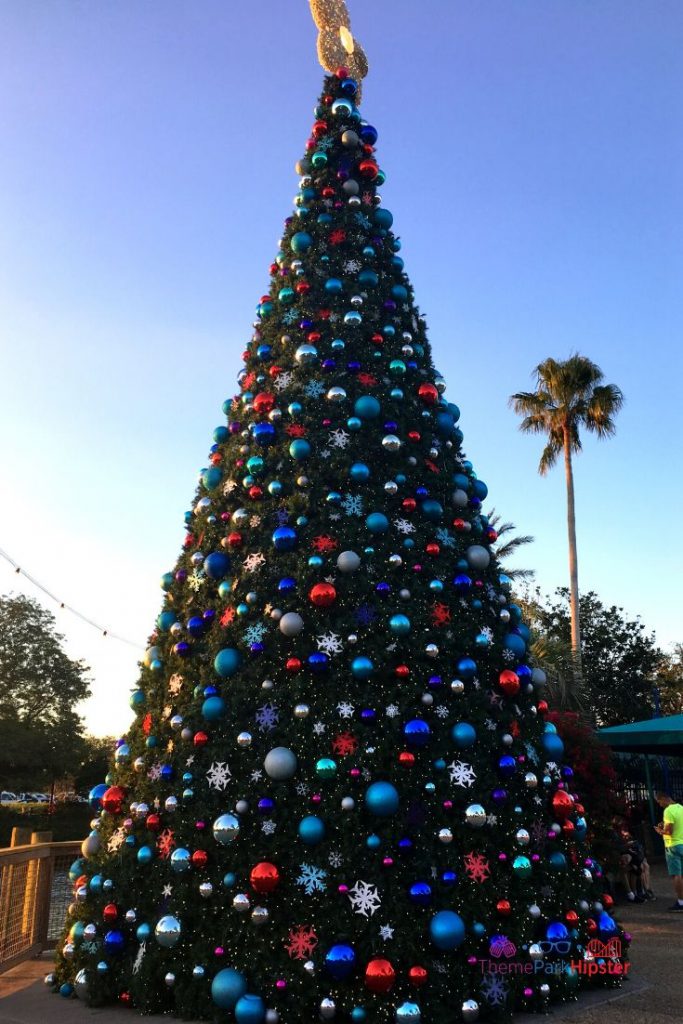 SeaWorld Christmas Celebration with Giant Christmas Tree and blue silver and red bulbs. Keep reading to learn about Christmas at SeaWorld Orlando!