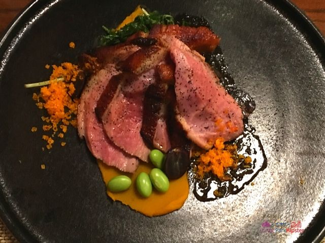 Takumi Tei Japanese Restaurant Epcot Kamo Rosu - Roasted Duck_ Marinated Duck, Kabocha Squash, Edamame Beans, Japanese Mizuna, Cured Duck Egg Yolk, Grape Reduction. Keep reading to find out which EPCOT Japanese Restaurant is the BEST?