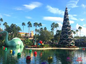 Christmas at Hollywood Studios Decorate Dinosaur in Santa Hat on Lake Echo