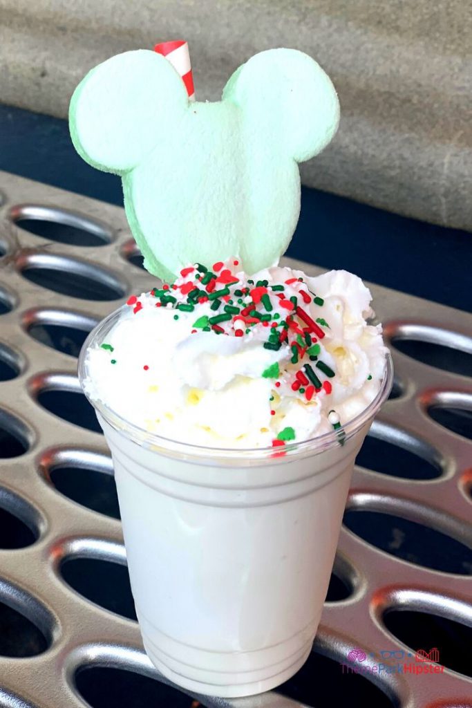 Mickeys Very Merry Christmas Party Sweet Treats Christmas at Disney Christmas Cookie Sundae (Available Daily at Auntie Gravity’s Galactic Goodies) – Cookie butter soft-serve topped with whipped cream, chocolate sauce, sprinkles, and a white chocolate piece. Keep reading to get the best Disney Christmas treats and desserts on this foodie guide.