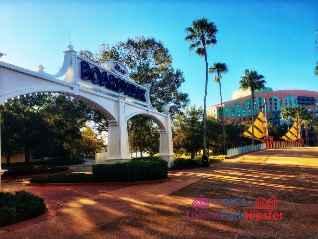 Disney Boardwalk Pier Entrance with Swan Hotel in the background. Keep reading to know how to choose the best Disney Deluxe Resorts for your vacation.