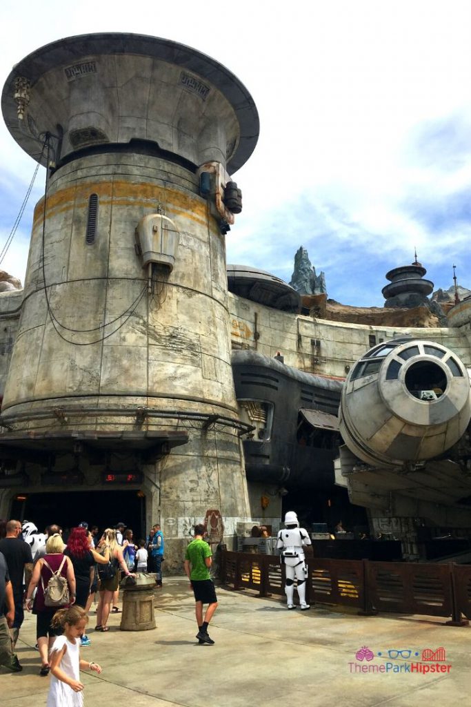 Star Wars Galaxy's Edge Entrance to Smugglers Run with Millennium Falcon in the background and Storm Trooper. Keep reading to know what to pack and wear to Disneyland in May for the perfect outfit.