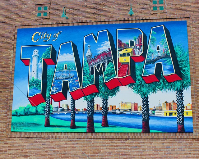 Tampa City Pass with classic welcome card painted on brick wall in Ybor City.