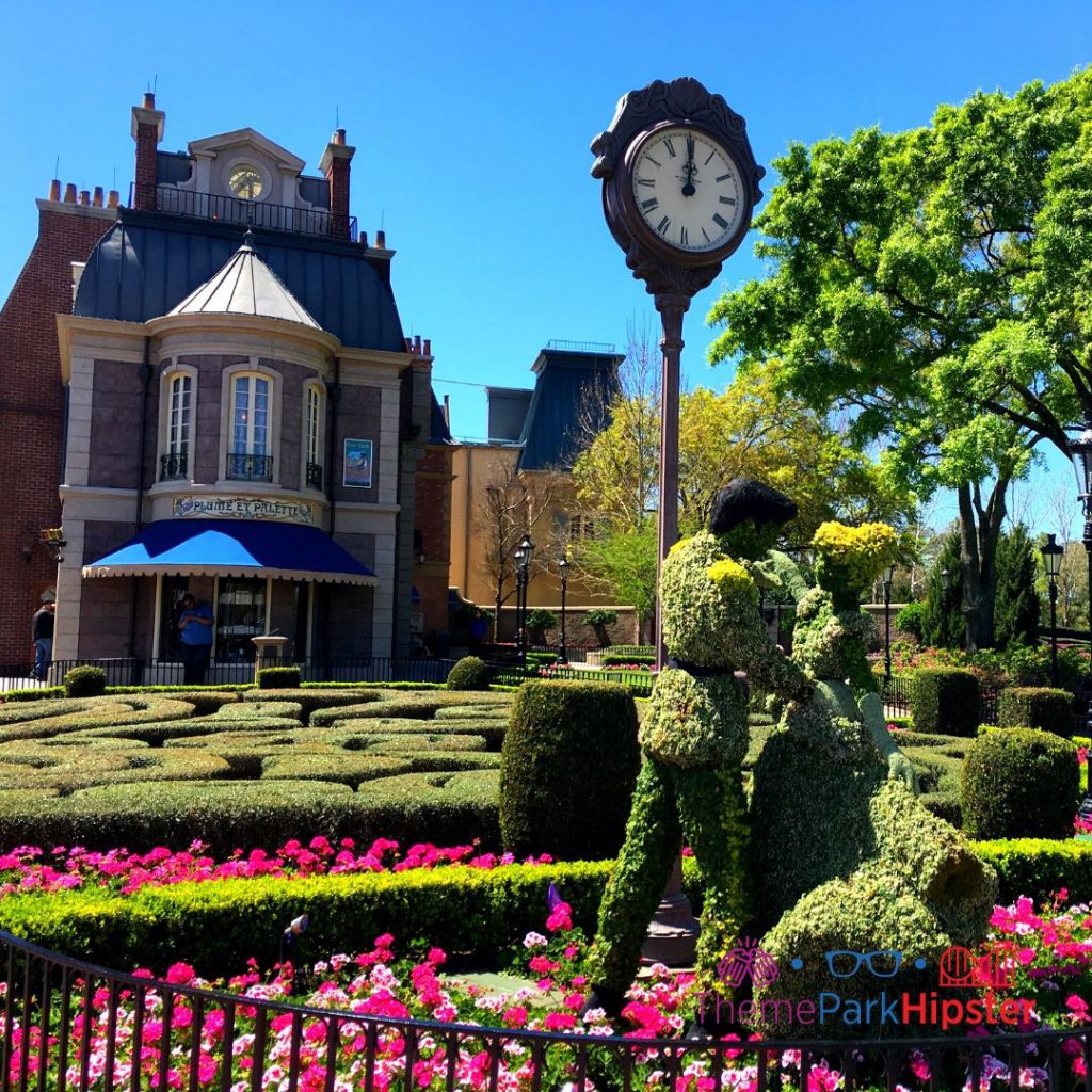 Epcot Flower and Garden Festival Cinderella and Prince Charming Topiary in France Pavilion. Keep reading to learn about going to theme parks alone and solo travel in Florida.