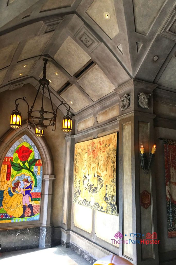 Be Our Guest Restaurant entryway with belle and prince stained glass window. Keep reading to learn about the Beast's Castle at Disney World.