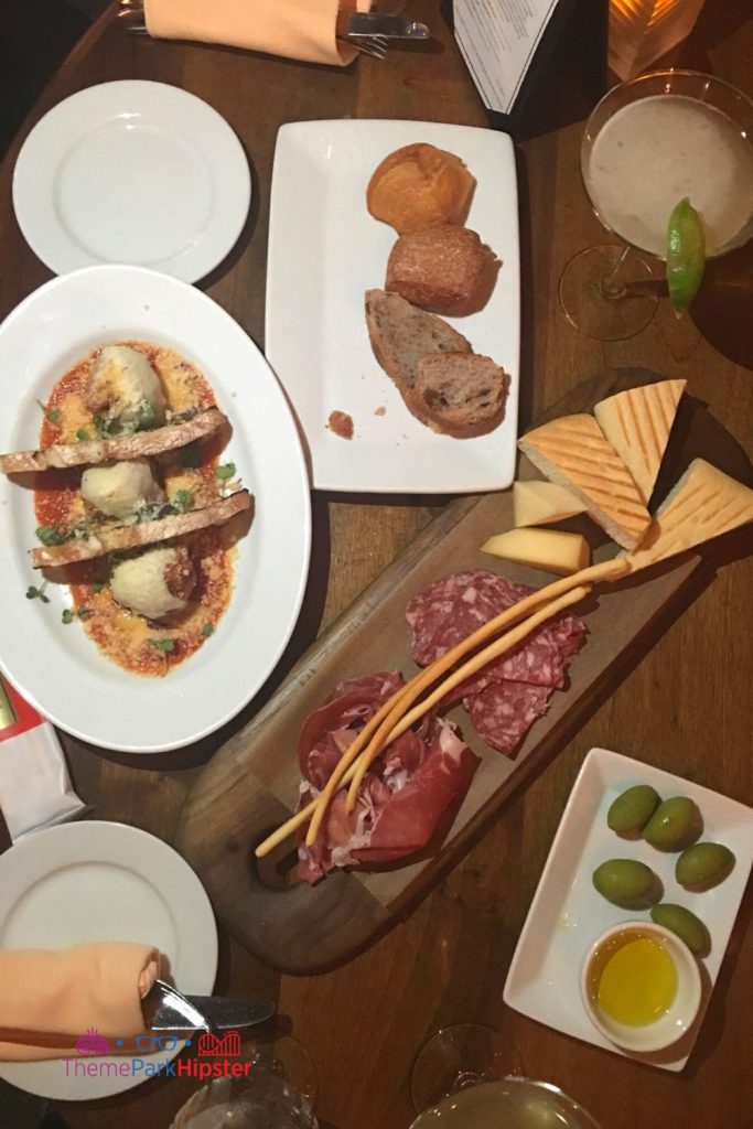 Tutto Gusto Wine Cellar in Italy Pavilion at Epcot Charcuterie Board with meatballs olives and Italian margarita. One of the best Restaurants at Epcot. 