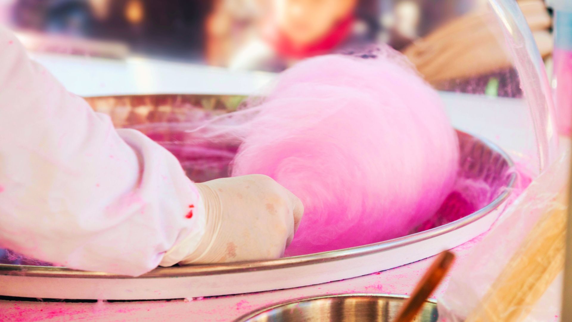 Cotton Candy at Disney World with Cast Member swirling the sweet treat