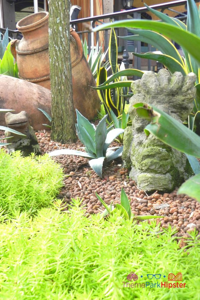 Epcot Mexico Pavilion Ancient Mexican statue among shrubbery