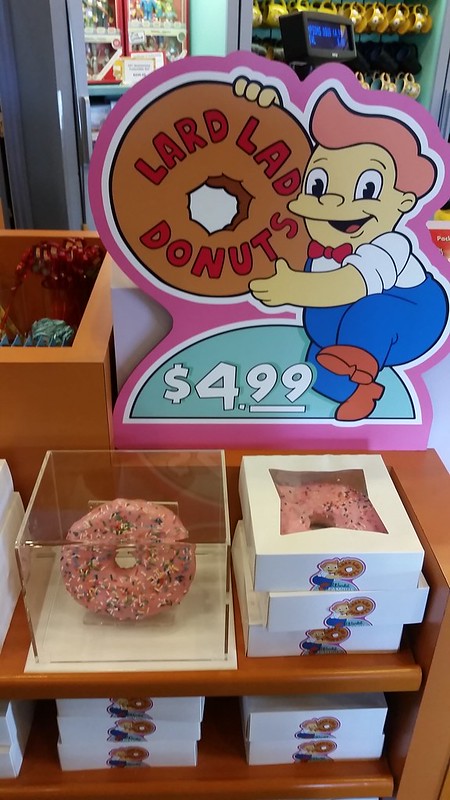 Display of Lard Lads Donuts' Big Pink Donut from The Simpsons at Universal Studios. Keep reading to find out what are the best Universal Orlando Snacks under $10.