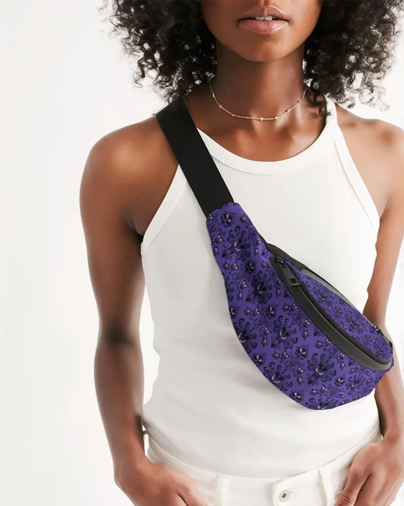 Black Lady wearing Disney Haunted Mansion Fanny Pack and Sling Bag. Keep reading for more Disney Haunted Mansion Merchandise Gift Ideas.