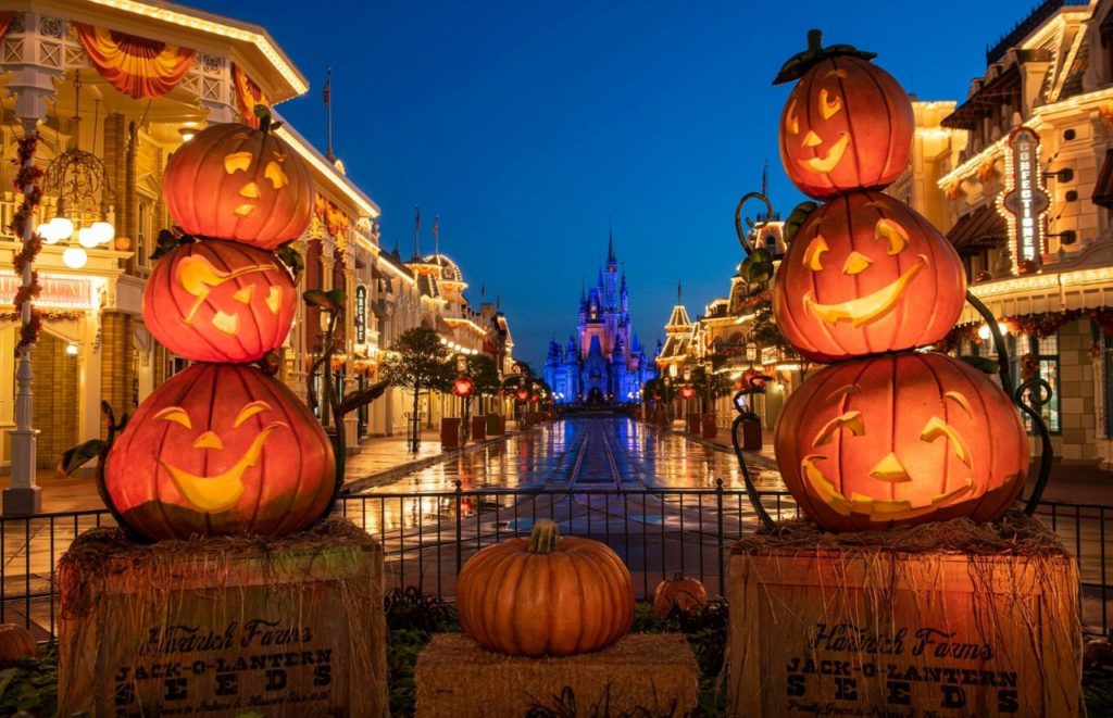 Disney Boo Bash Magic Kingdom Halloween Main Street USA with Cinderella Castle. Keep reading for more Halloween at Disney things to do and events with fall decor.