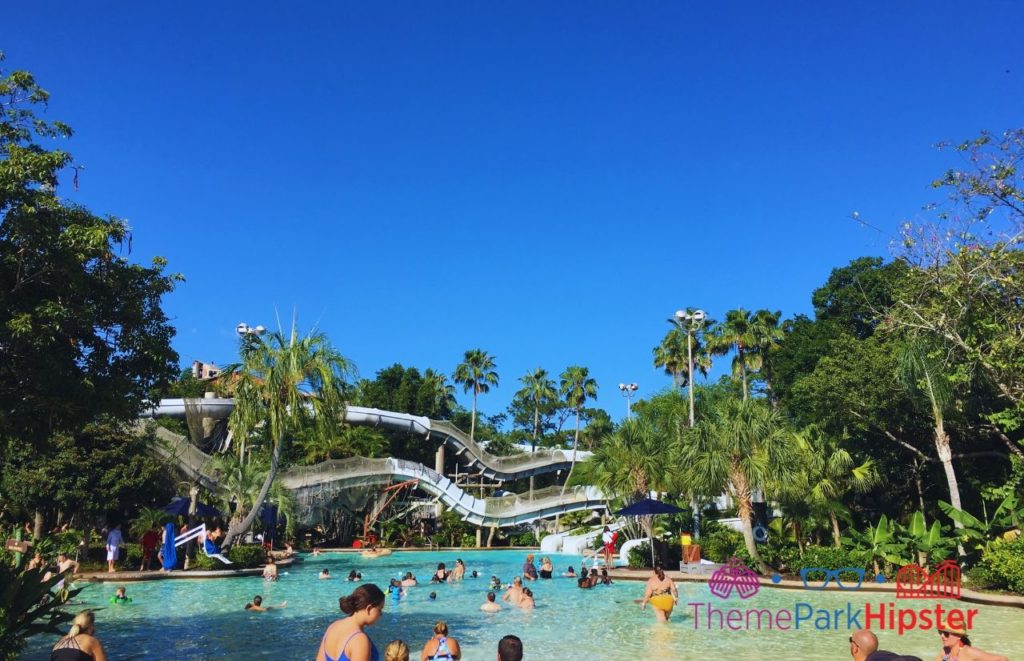 Typhoon Lagoon Gusher Roller Coaster in blue Florida sky next to pool. Keep reading to see what's the best Disney water park in our Typhoon Lagoon vs Blizzard Beach guide!