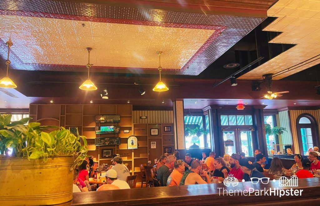 Interior of Universal Orlando Finnegan's Bar and Grillfilledwith guests in the middle of the room dining and drinking. Keep reading to find out more about the best bars at Universal Orlando.  